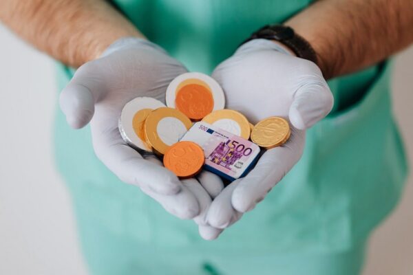 faceless doctor with chocolate coins in hands 4021809