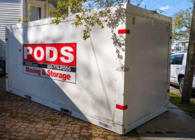 Large PODS moving and storage container on driveway, ready for convenient packing and transportation.